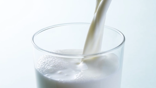 Close-up of milk pouring into a glass
