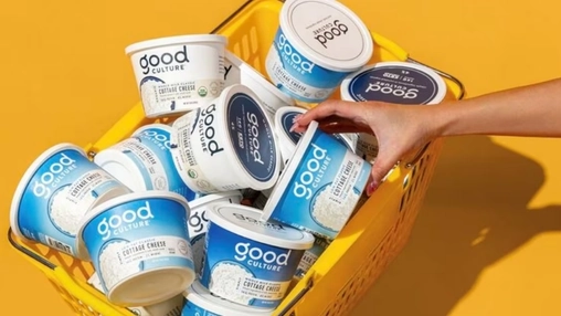 Hand picking Good Culture cottage cheese from yellow basket